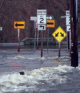 Water streaming across a flooded road